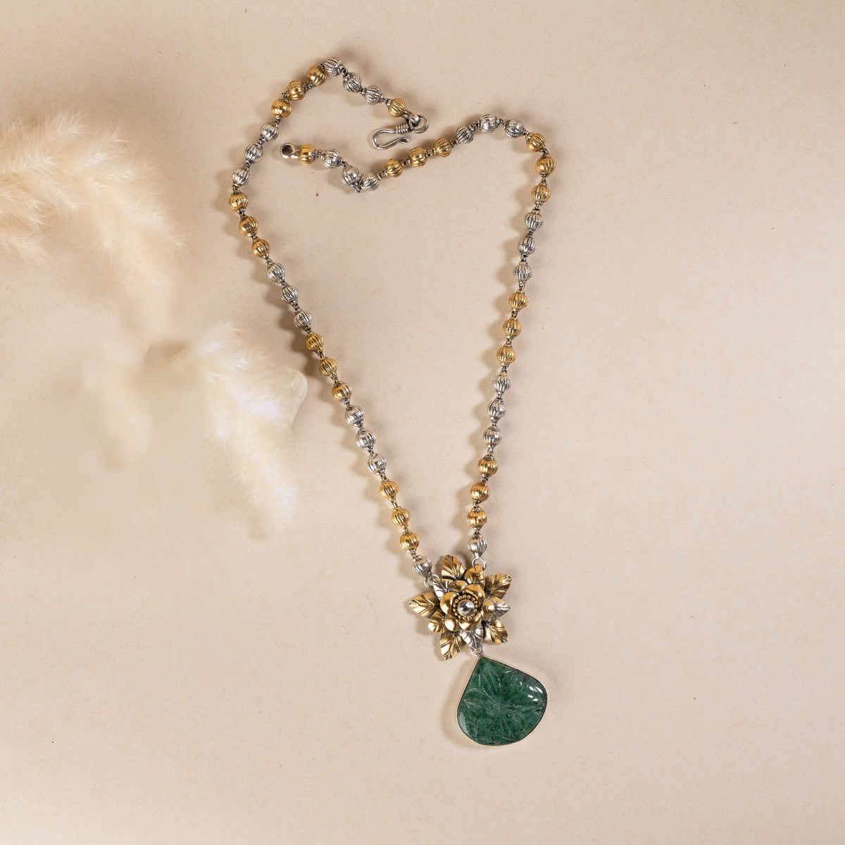Long sterling silver necklace with a big green colour stone at centre, adding a touch of sophistication to any outfit